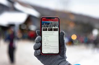 a person holding a cell phone with the app open