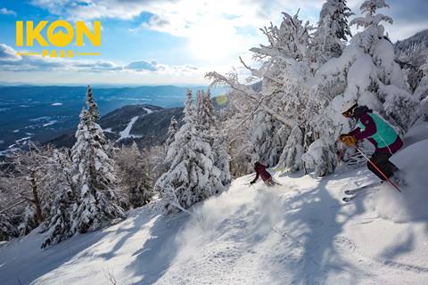 Ikon logo on image of skiers with lincoln peak in the background 