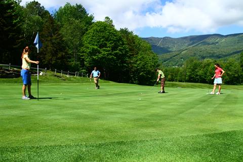 Four Golf players at the hole 