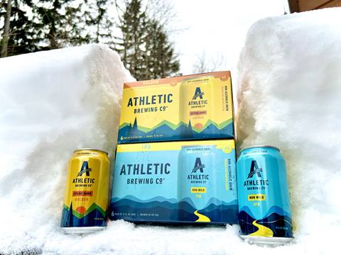 Athletic brewing cans and cases in the snow