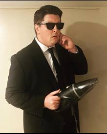dennis ronney in suit and sunglasses
