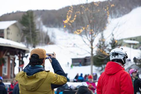 guy taking photo of mountain on phone