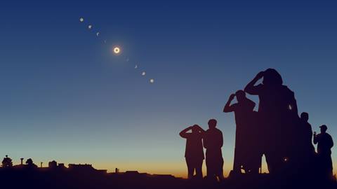 stock image of people viewing a solar eclipse