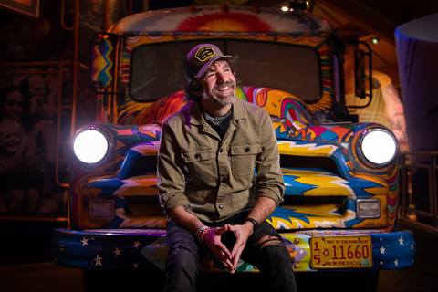 stephen kellogg sitting on a colorful bus