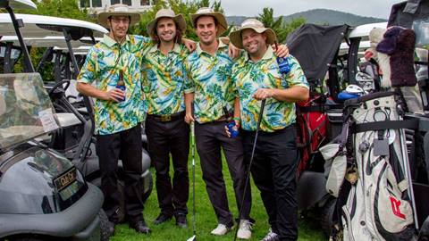 A group of golfers smiling at the camera