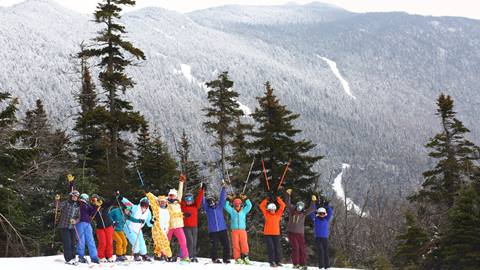 A group laughing and skiing
