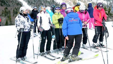 A group laughing and skiing