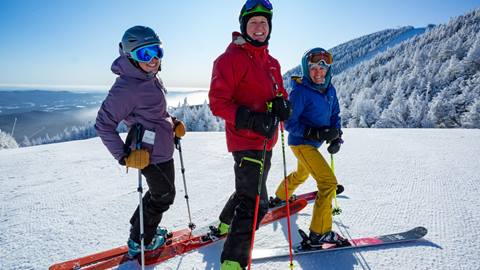 A group laughing and skiing