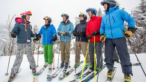 A group laughing and skiing