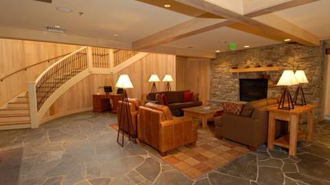 Step into luxury: the lobby's grand staircase and stone fireplace await. 