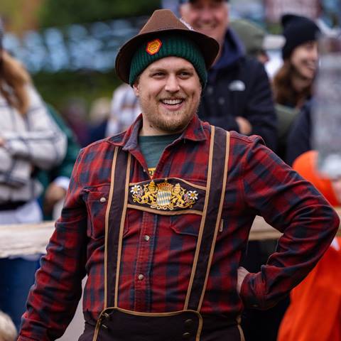 A man in tradition German attire smiling 