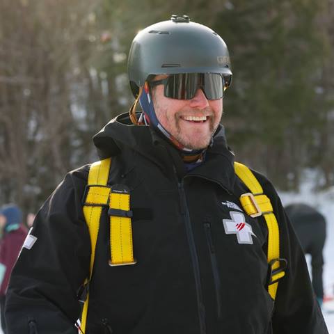 A ski patroller smiling 