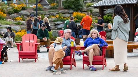 Couple in chairs smiling in the courtyard