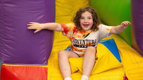 A little girl playing in a bounce house