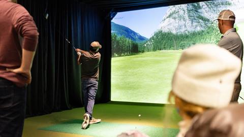 Group playing golf in the SIM Suites