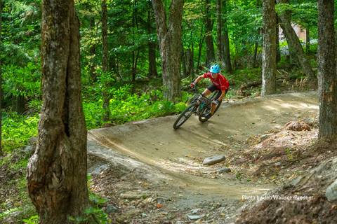 A women mountain biking down a flow trail 