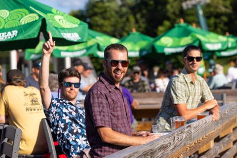 Some happy men enjoying some beers on the Big Deck. 