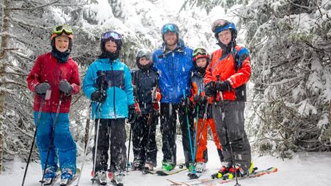 Kid skiing or snowboarding in a lesson