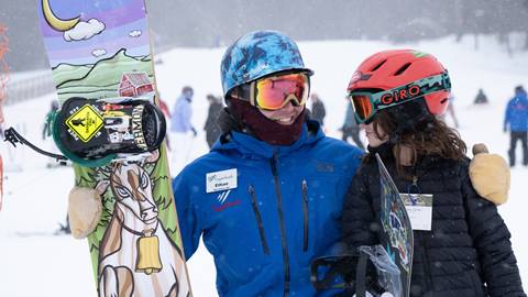 Kid skiing or snowboarding in a lesson