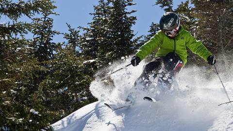 Kid skiing or snowboarding in a lesson