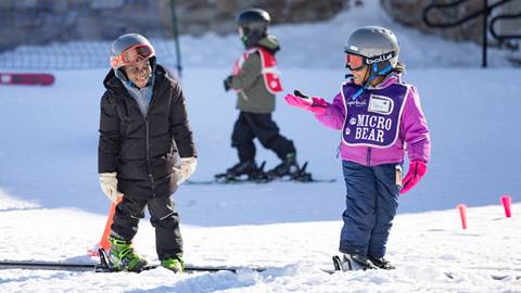Kids smiling on the First Timer Lift in a ski lesson 