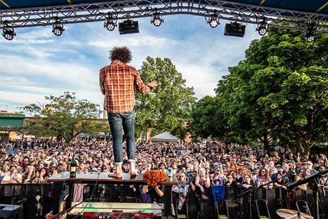 Andy Frasco standing on a piano