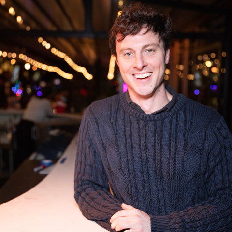 headshot of comedian in a bar