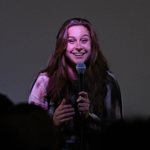 headshot of a comedian performing on stage