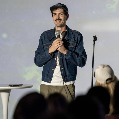 photo of comedian twon wood on stage performing
