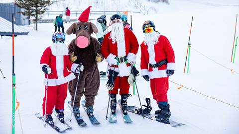 A couple of Santa skiers and Murphy the Moose