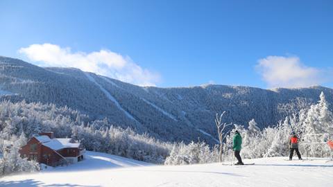 Skiers under a bluebird sky
