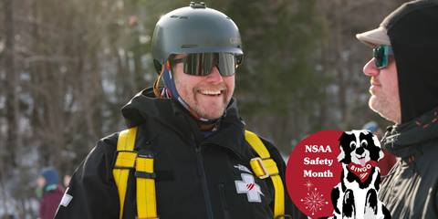 ski patroller smiling with helmet on 
