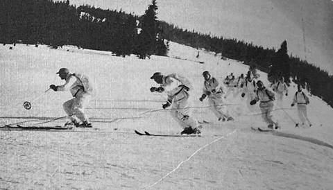 historical photo of 10th mountain division skiing with rucksacks