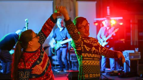 Dancers in Christmas sweaters at the SugarBash