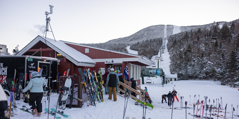 exterior of walts surrounded by skis and people walking inside