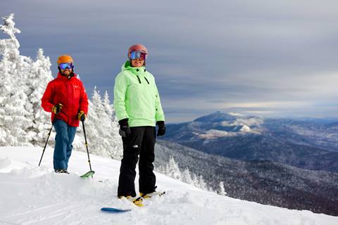 Skier and rider at Sugarbush Resort on a powder day getting first tracks