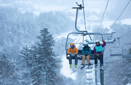 Family at Sugarbush Resort riding first chair on a powder day in Vermont