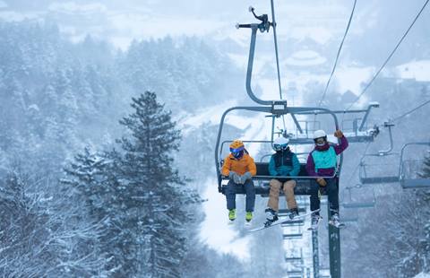 Family at Sugarbush Resort riding first chair on a powder day in Vermont 