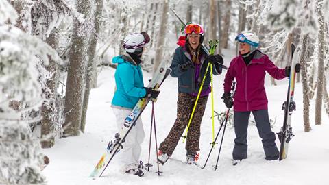Women smiling in the woods