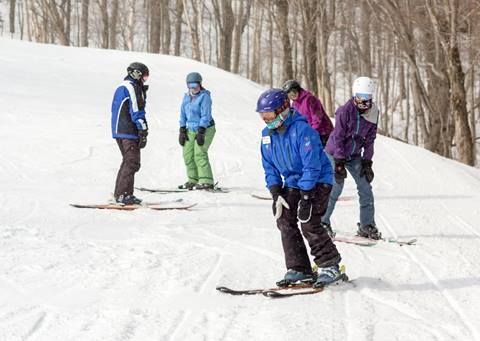 An Instructor leading a group lesson on skis