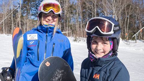 Snowboarders smiling at the camera
