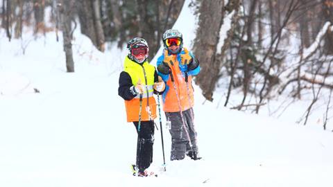Kids skiing and smiling 