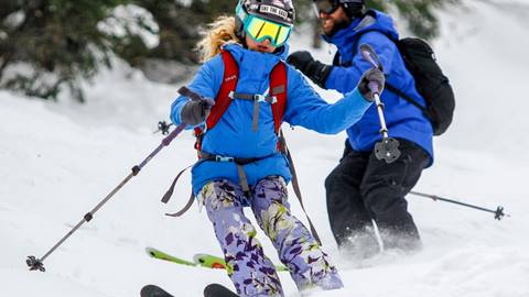 A girl skiing facing downhill