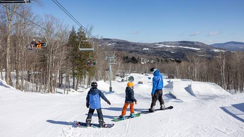 A group of kids snowboarding