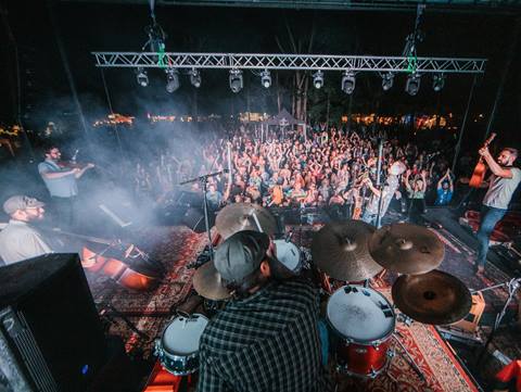 The band Cabinet on stage in front of a large crowd at night