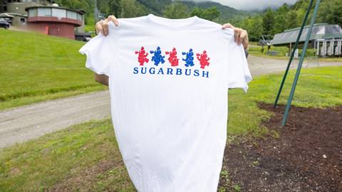 Someone holding up the t-shirt