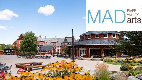 Flowers in the courtyard with MAD RIVER VALLEY ARTS logo in the corner