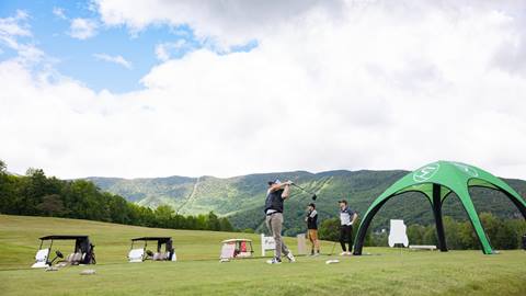 A golfer teeing off