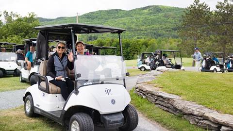 Women smiling in a golf cart