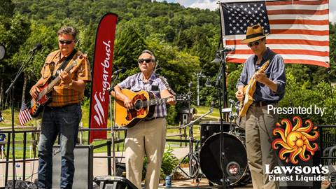 Musicians with an american flag behind them